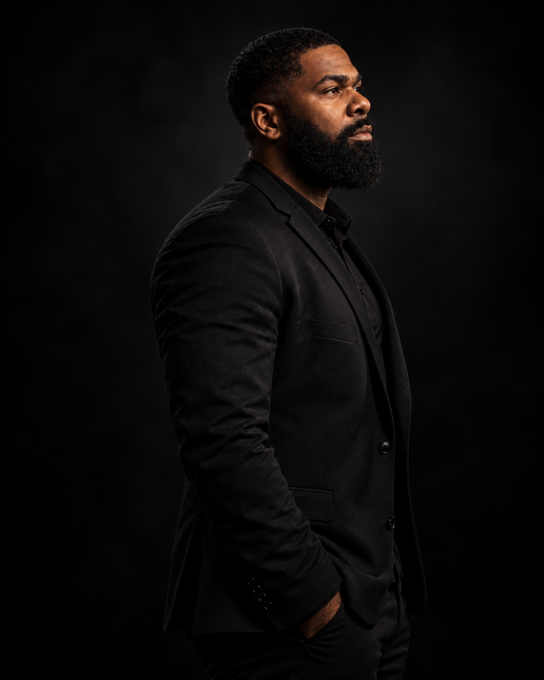 A side profile portrait in a black blazer